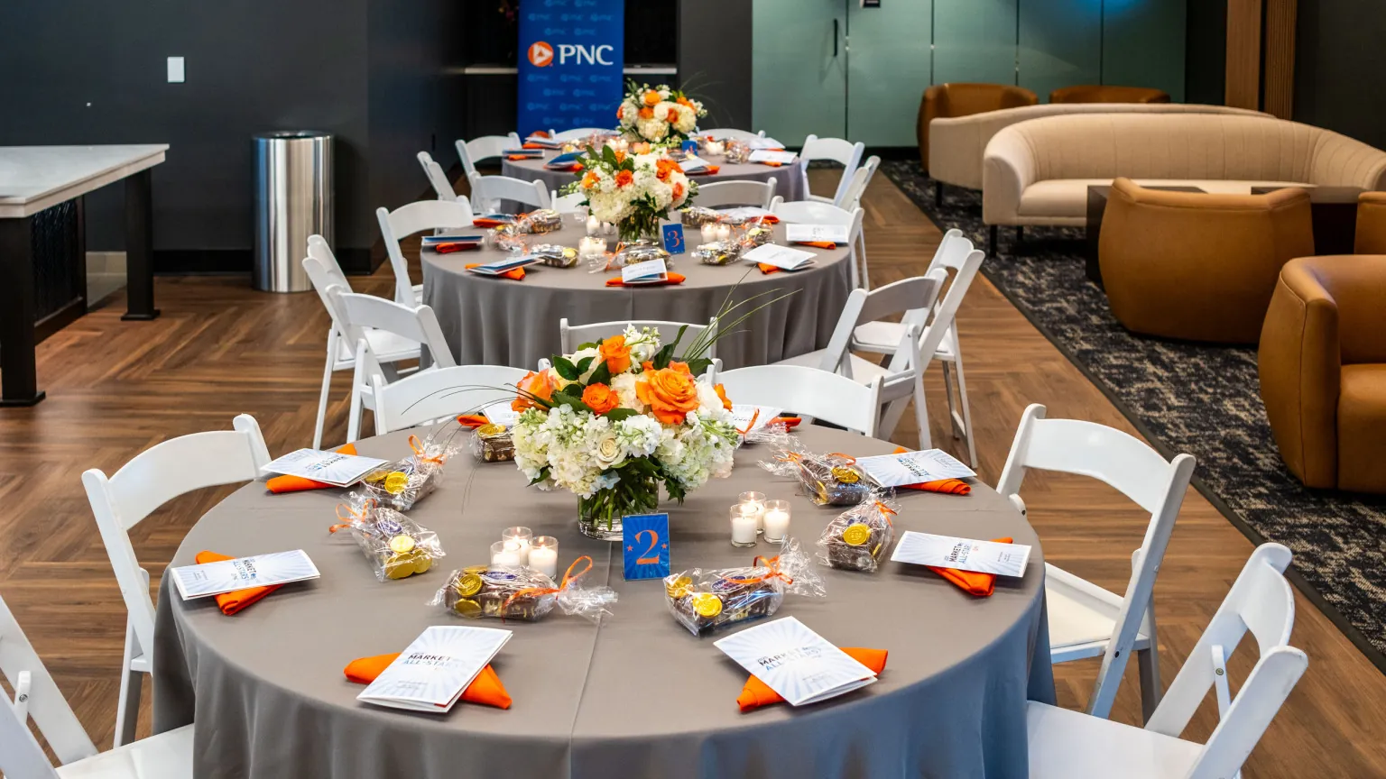 Round tables prepared for a catered ballpark event