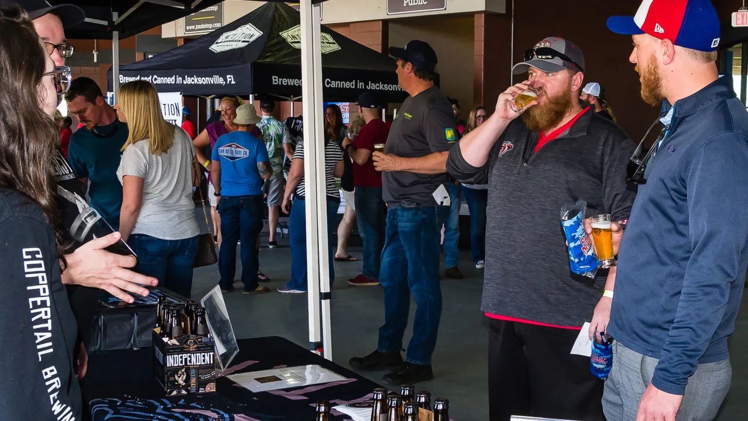 Guests sampling drinks from local vendors on the concourse