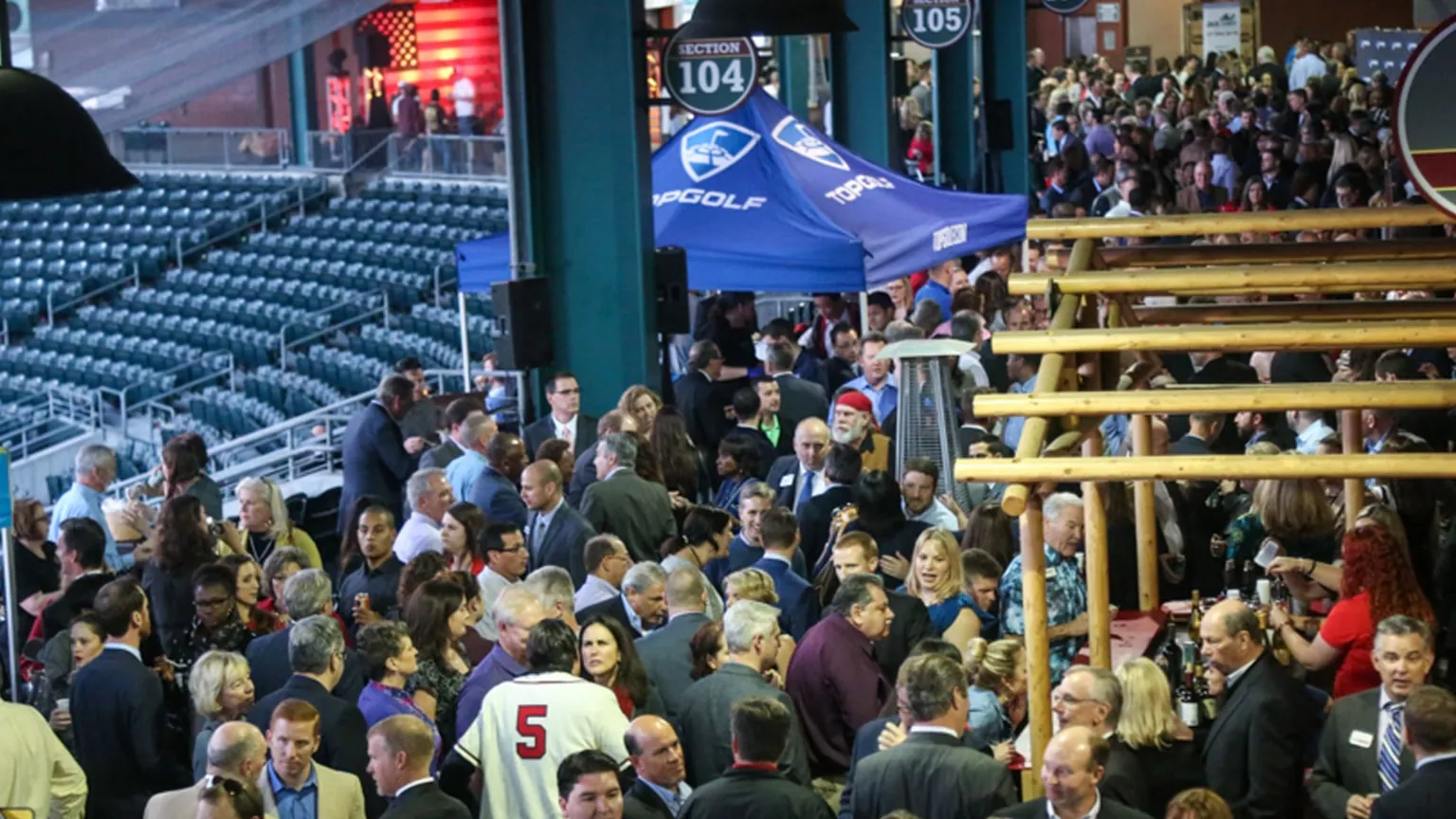 A large crowd gathering on the ballpark concourse