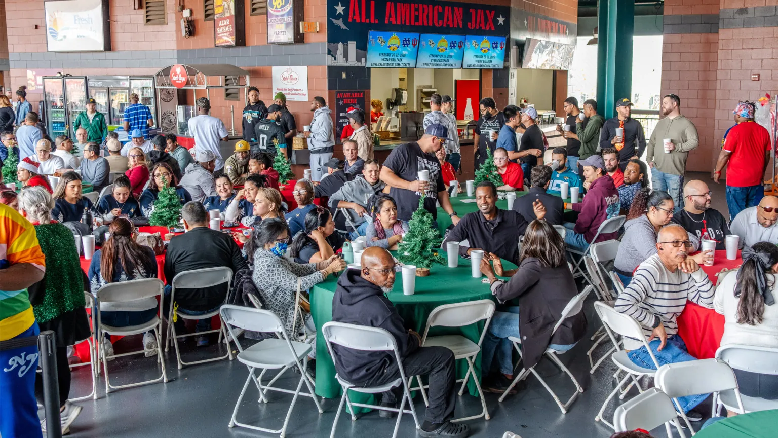 A busy banquet with round tables filling the concourse