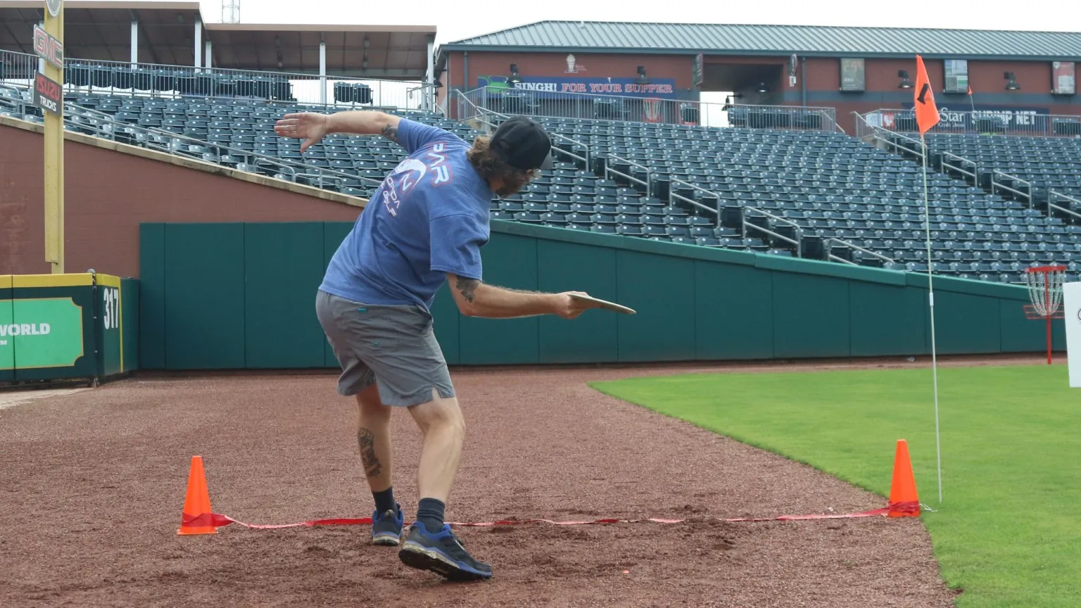 A guest playing a team-building game near the warning track