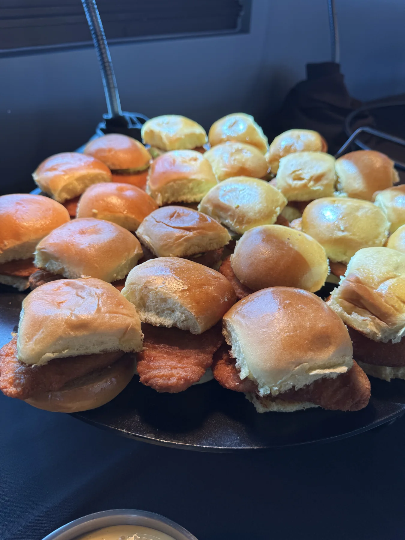 Tray of crispy chicken sliders on toasted rolls