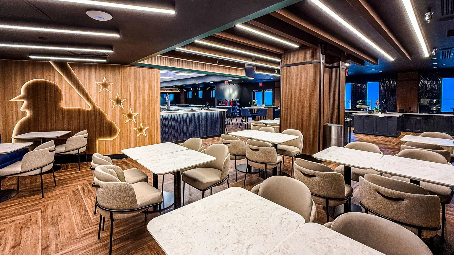 Modern lounge chairs and tables inside PNC Home Plate Club