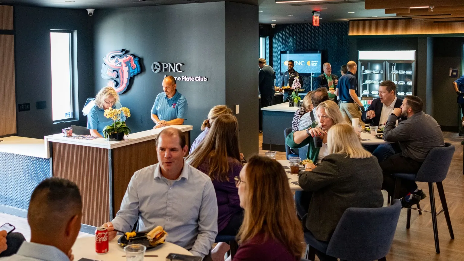Guests mingling at a reception inside PNC Home Plate Club
