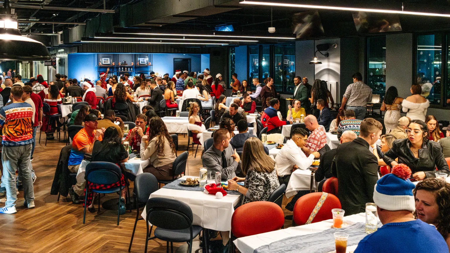 Guests dining at round tables inside Harbour Hall